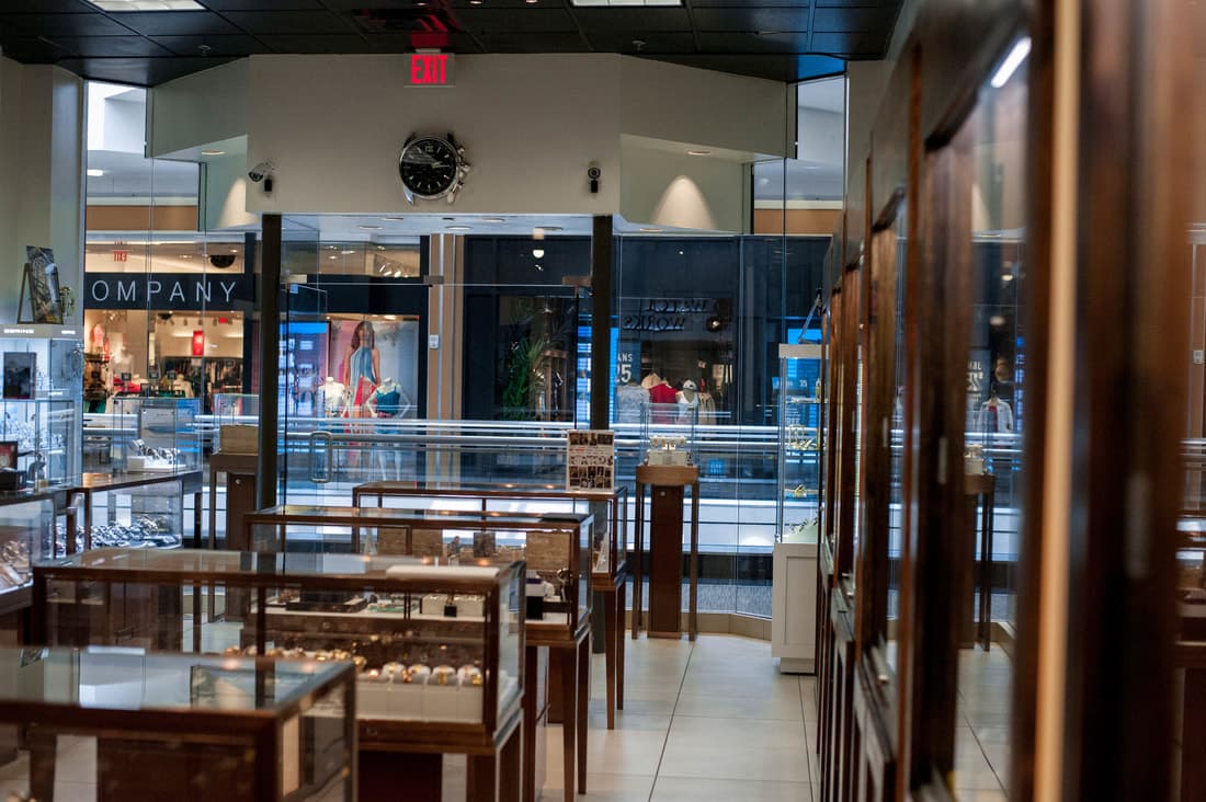 Interior of jewelry and watch retail store with display cases and glass storefront