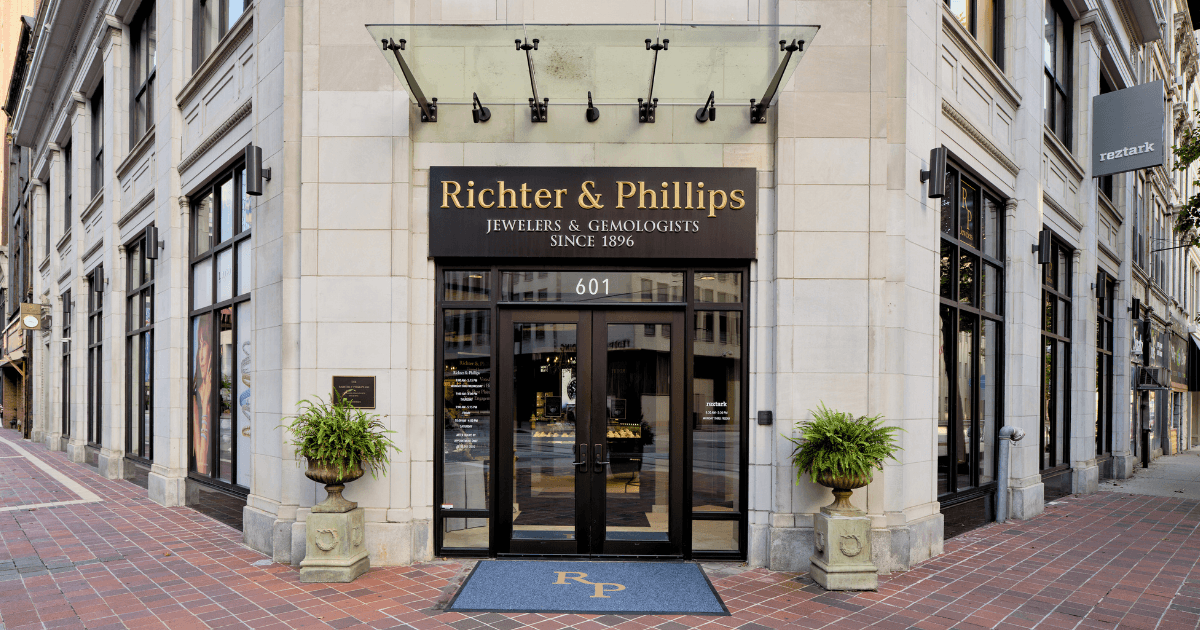 Storefront of Richter & Phillips Jewelers with cream facade, dark entrance doors, and planters